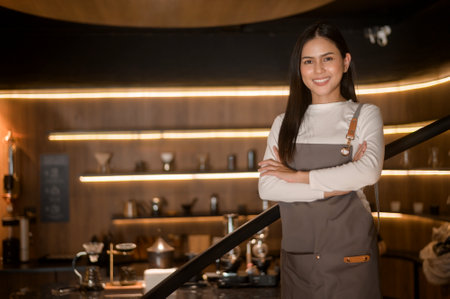 A young woman barista working in modern coffee shopの写真素材
