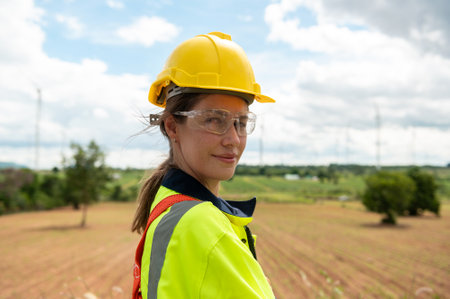 Portrait of smart engineer with protective helmet at electrical turbines fieldの写真素材