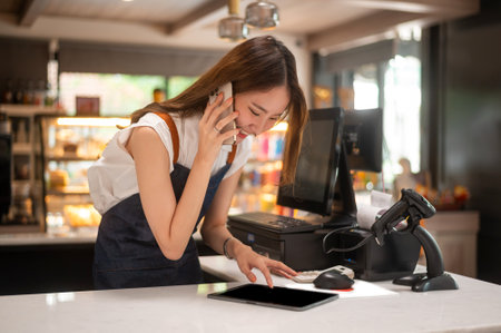 An Asian young Cashier woman working in supermarketの写真素材