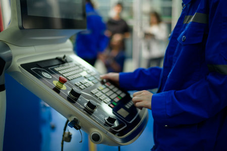 Close up of Robotics engineers Using Controller to Remotely Operate programming and Manipulating Robot Hand, Industrial Robotics Design, High Tech Facility, Modern Machine Learning. Mass Production Automatics.の写真素材