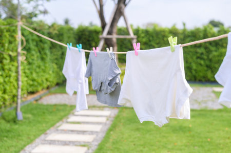Clothes hanging laundry on washing line for drying against blue sky outdoor