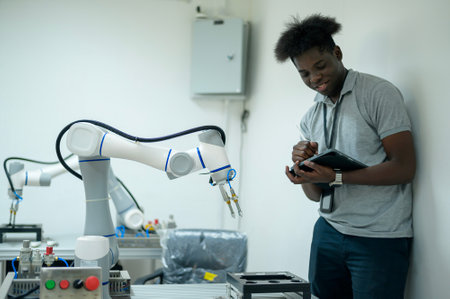 Trainee Robotics engineer learning with Programming and Manipulating Robot Hand, Industrial Robotics...