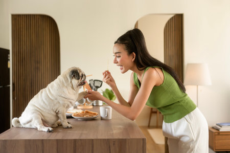 Asian woman preparing coffee and toast bread for breakfast enjoy with dog at the kitchen table in the morningの写真素材