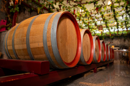 Old wooden wine barrels stacked in a cellar in order