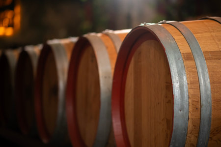 Old wooden wine barrels stacked in a cellar in order