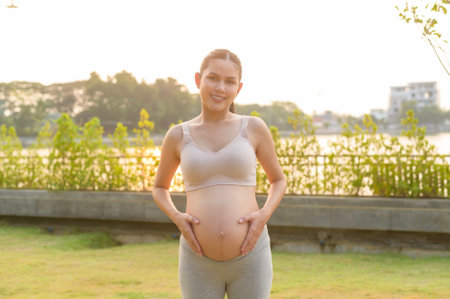 Portrait of Beautiful pregnant woman in the park, Healthy and active pregnancy lifestyle concept.の写真素材