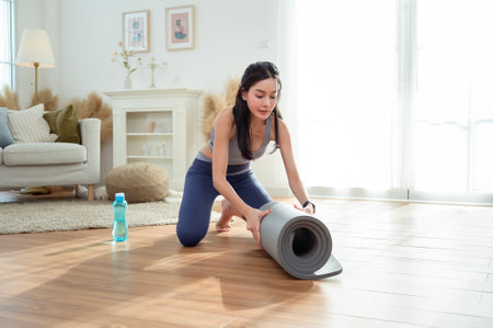 Asian woman in sportswear exercising and doing yoga in living room at home