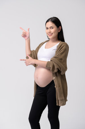 Portrait of Beautiful pregnant woman on white backgroundの写真素材