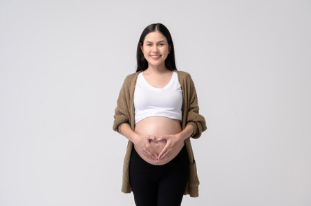 Portrait of Beautiful pregnant woman on white backgroundの写真素材