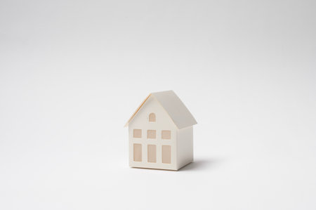 A small  house model on a white surface showcases its minimalistic design.の写真素材