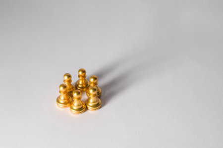 Golden pawns are positioned closely together, indicating possible strategy and teamwork.