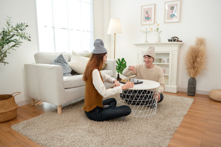 Two friends concentrate on their game, enjoying each other's company in a warm setting.の写真素材