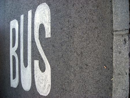 The bus line sign over asfalt of a city street. Copy space avaialble.の写真素材