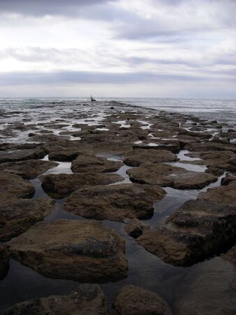 View of a fisherman on a pier at Benicasim, Spain.の写真素材