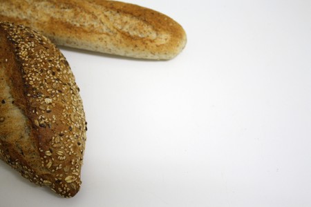 A french baguette and a german bread isolated on a white background, copy space available.の写真素材
