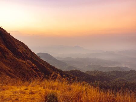 beautiful nature of the hills with golden grass and mountain range in the morning in Tak, Thailand.の素材 [FY310141383990]