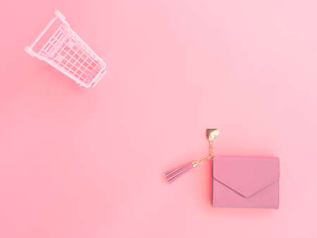 shopping and payment concept from pink purse and small trolley on pink pastel color background.の写真素材