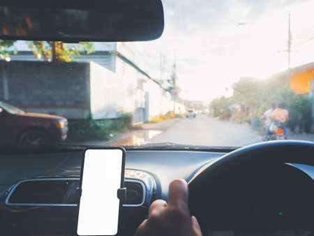 Blank empty screen smartphone on holder in car use for Navigation or GPS. Car interior view.の写真素材