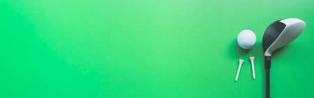 Golf equipment flat lay on green background. Top view