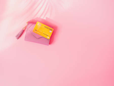shopping and payment concept from pink wallet with credit cards or discount card on pink background.