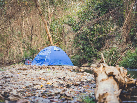 summer camping tent near the stream.の写真素材