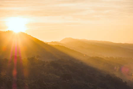Sun sunrise bright sunlight over mountain.の写真素材
