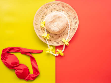 summer accessories concept from straw hat and red bikini on colorful background.の写真素材