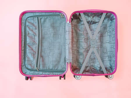 open empty suitcase on pink background.の写真素材