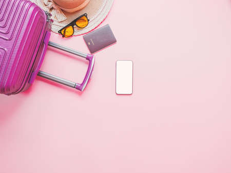 Summer traveler accessories on pink background, Smartphone with blank screen.の写真素材