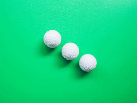 Top view of golf ball on green background.の写真素材