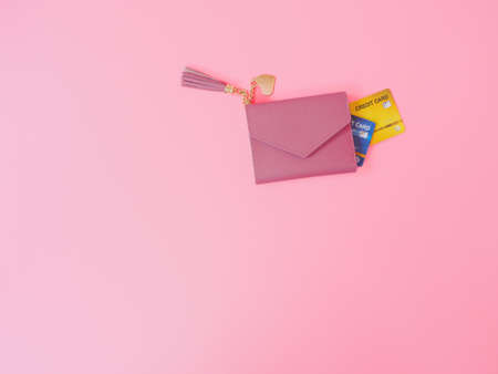 shopping and payment concept from pink wallet with credit cards or discount card on pink background.の写真素材
