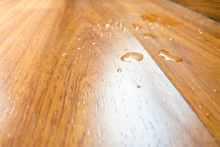 water spill on parquet wood floor, which leaking from air conditioner in the house.の写真素材
