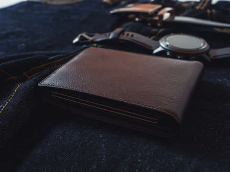 Brown leather wallet on jeans background.の写真素材