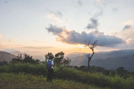 Men backpacker are happy and enjoy with sunset after successful hiking.
