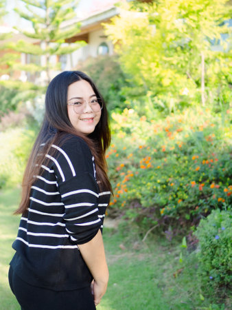 Young chubby Asian woman is confident and smiling looking at camera.の写真素材