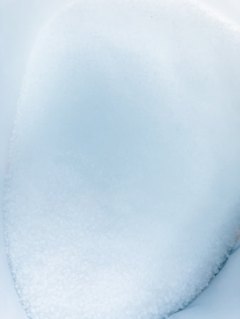 Close-up of white plastic pellets used as raw material for injection molding.
