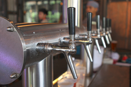 Beer tap in a row.