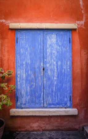 Window vintage with orange wall.の写真素材