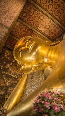 Buddha gold statue face  in the Temple of the Reclining Buddha , Wat Pho, Bangkok, Thailand,の写真素材
