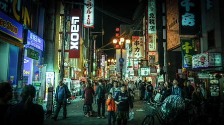 Osaka, Japan - April 1, 2018 :Tourist walking in night shopping street at Dotonbori, Dotonbori the famous destination for traveller in Osaka City, Osaka, Japan.のeditorial素材