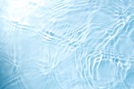 Blurred transparent blue colored water surface  with splash and bubbles