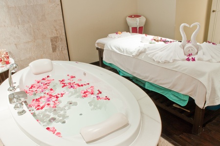 Spa  with bath  surrounded by rose petalsの写真素材