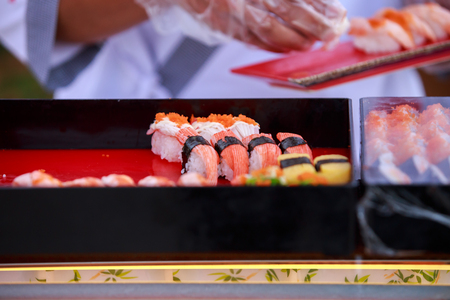 fresh sushi and rolls on the plate with chopsticksの写真素材