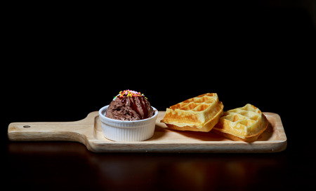 Ice cream  and fruit on wooden plateの写真素材
