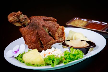 Fried pork leg on white plate on a wooden board,の写真素材