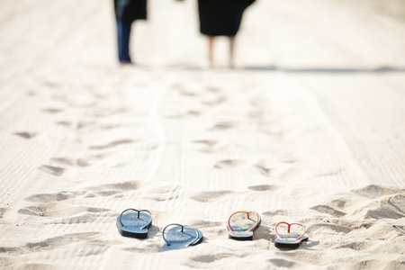 Women and men wearing Graduation  clothing for a walk by the seaの写真素材