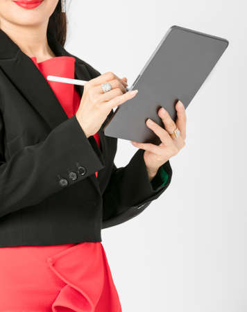Business woman working wearing suit holding on tabletの写真素材