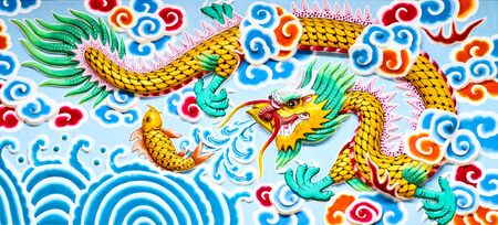dragon painting on marble wall of chinese temple in thailandの写真素材