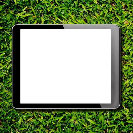 tablet computer pc with isolated screen on green grassの写真素材