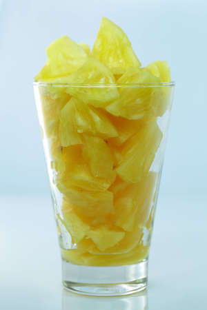 Slices pineapple in a glass の写真素材